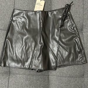 Black faux leather skirt shorts, brand new with tags, size medium